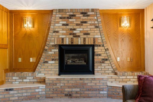 23 Millside Place Sw, Calgary, AB - Indoor Photo Showing Living Room With Fireplace