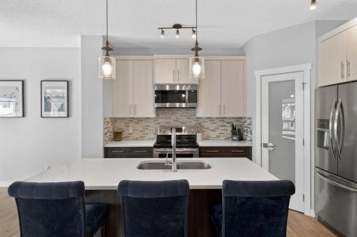 42 Baysprings Way Sw, Airdrie, AB - Indoor Photo Showing Kitchen With Stainless Steel Kitchen With Double Sink With Upgraded Kitchen