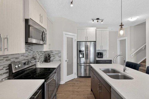 42 Baysprings Way Sw, Airdrie, AB - Indoor Photo Showing Kitchen With Stainless Steel Kitchen With Double Sink With Upgraded Kitchen