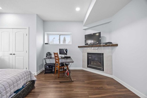 282 Pantego Terrace Nw, Calgary, AB - Indoor Photo Showing Bedroom With Fireplace
