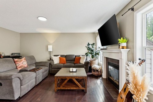 943 Windsong Drive Sw, Airdrie, AB - Indoor Photo Showing Living Room With Fireplace