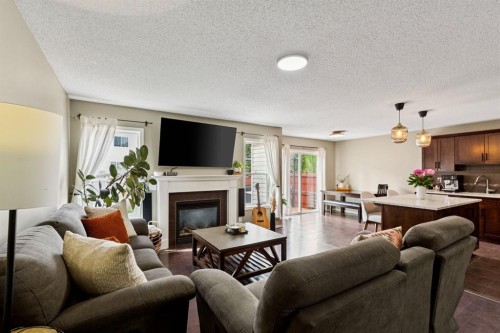 943 Windsong Drive Sw, Airdrie, AB - Indoor Photo Showing Living Room With Fireplace