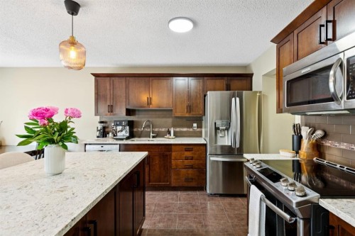 943 Windsong Drive Sw, Airdrie, AB - Indoor Photo Showing Kitchen With Stainless Steel Kitchen With Upgraded Kitchen