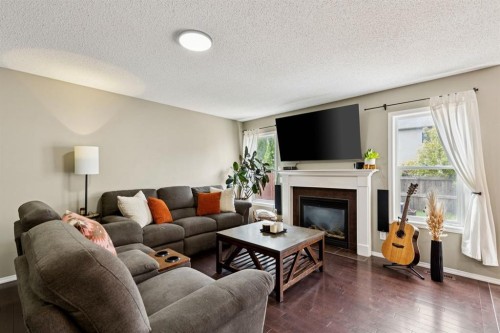 943 Windsong Drive Sw, Airdrie, AB - Indoor Photo Showing Living Room With Fireplace