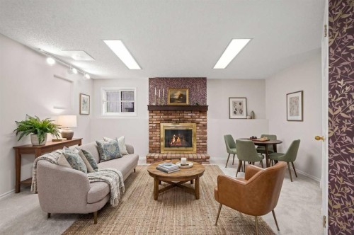 107 Tararidge Close Ne, Calgary, AB - Indoor Photo Showing Living Room With Fireplace