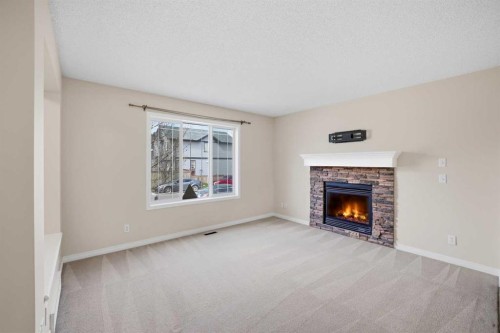 35 Saddlebrook Link Ne, Calgary, AB - Indoor Photo Showing Living Room With Fireplace