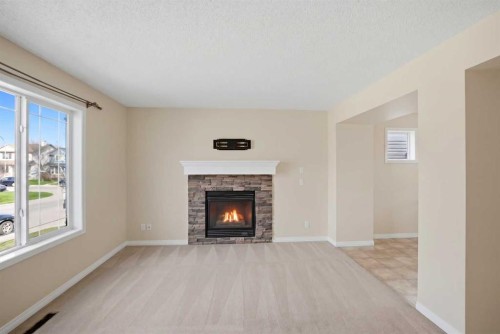 35 Saddlebrook Link Ne, Calgary, AB - Indoor Photo Showing Living Room With Fireplace