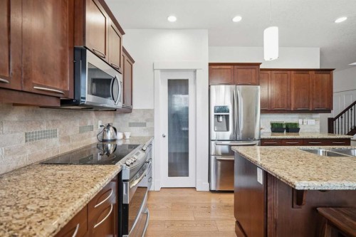 114 Cougarstone Crescent Sw, Calgary, AB - Indoor Photo Showing Kitchen With Double Sink With Upgraded Kitchen