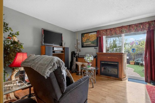 106-6223 31 Avenue Nw, Calgary, AB - Indoor Photo Showing Living Room With Fireplace
