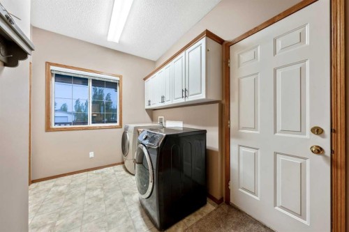46 4 Street Ne, Langdon, AB - Indoor Photo Showing Laundry Room