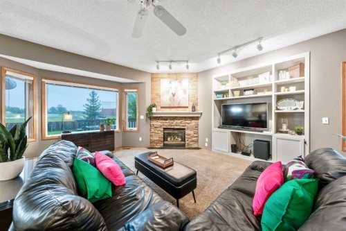 46 4 Street Ne, Langdon, AB - Indoor Photo Showing Living Room With Fireplace