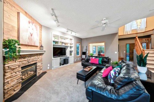 46 4 Street Ne, Langdon, AB - Indoor Photo Showing Living Room With Fireplace