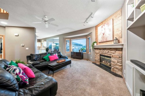 46 4 Street Ne, Langdon, AB - Indoor Photo Showing Living Room With Fireplace