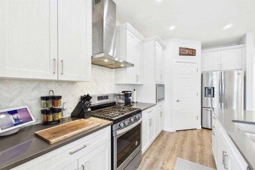 34 Birch Glen, Okotoks, AB - Indoor Photo Showing Kitchen With Stainless Steel Kitchen With Upgraded Kitchen