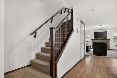 22 Autumn Green Se, Calgary, AB - Indoor Photo Showing Other Room With Fireplace