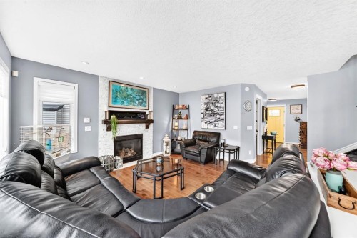 116 Kingsland Court Se, Airdrie, AB - Indoor Photo Showing Living Room With Fireplace