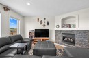 184 Somerglen Common Sw, Calgary, AB  - Indoor Photo Showing Living Room With Fireplace 