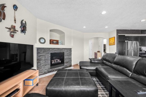 184 Somerglen Common Sw, Calgary, AB - Indoor Photo Showing Living Room With Fireplace