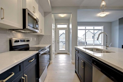 2085 Cobblespring Avenue Sw, Airdrie, AB - Indoor Photo Showing Kitchen With Stainless Steel Kitchen With Double Sink With Upgraded Kitchen