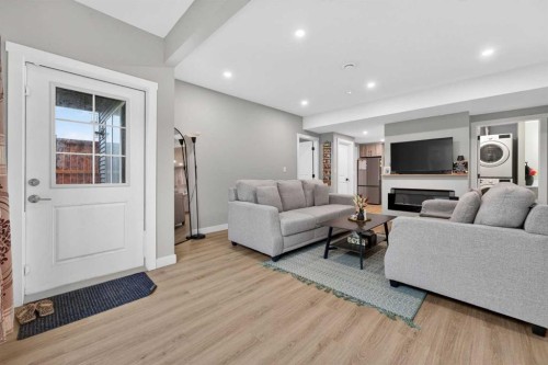 109 Kinniburgh Cove, Chestermere, AB - Indoor Photo Showing Living Room With Fireplace