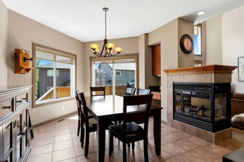 23 Aspen Stone Crescent Sw, Calgary, AB - Indoor Photo Showing Dining Room With Fireplace