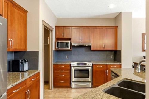 23 Aspen Stone Crescent Sw, Calgary, AB - Indoor Photo Showing Kitchen With Double Sink