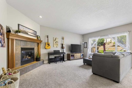 122 Discovery Ridge Way Sw, Calgary, AB - Indoor Photo Showing Living Room With Fireplace