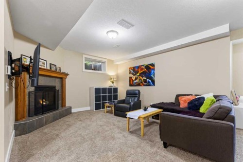 122 Discovery Ridge Way Sw, Calgary, AB - Indoor Photo Showing Living Room With Fireplace