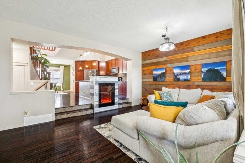 1807 New Brighton Drive Se, Calgary, AB - Indoor Photo Showing Living Room With Fireplace