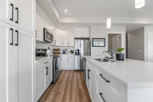 258 Canals Crossing Sw, Airdrie, AB - Indoor Photo Showing Kitchen With Double Sink With Upgraded Kitchen