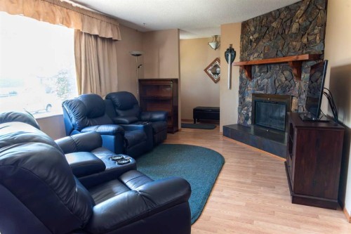 164 Huntford Road Ne, Calgary, AB - Indoor Photo Showing Living Room With Fireplace