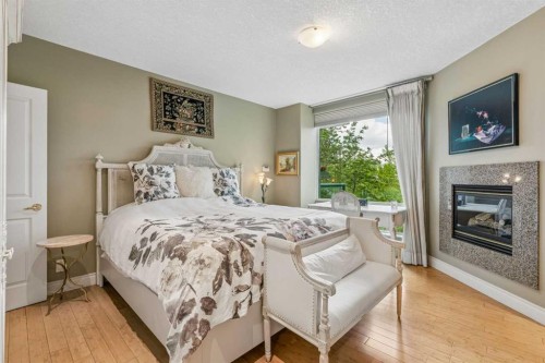303-837 2 Avenue Sw, Calgary, AB - Indoor Photo Showing Bedroom With Fireplace