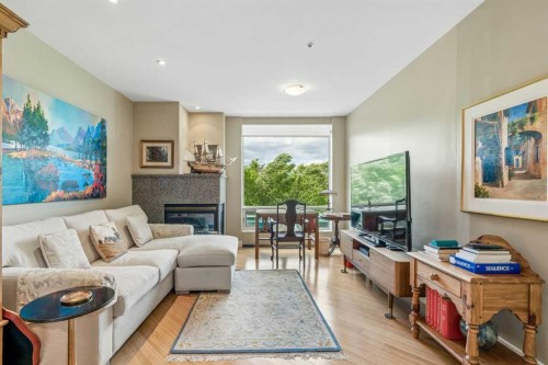 303-837 2 Avenue Sw, Calgary, AB - Indoor Photo Showing Living Room With Fireplace
