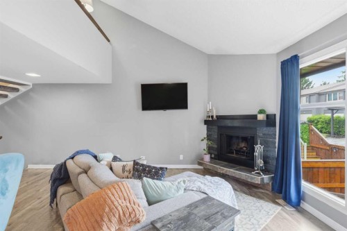 57-2225 Oakmoor Drive Sw, Calgary, AB - Indoor Photo Showing Living Room With Fireplace