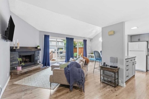 57-2225 Oakmoor Drive Sw, Calgary, AB - Indoor Photo Showing Living Room With Fireplace