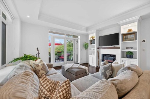 102-211 Quarry Way Se, Calgary, AB - Indoor Photo Showing Living Room With Fireplace