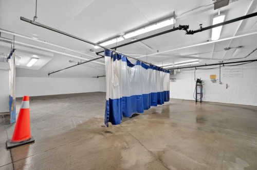 102-211 Quarry Way Se, Calgary, AB - Indoor Photo Showing Garage