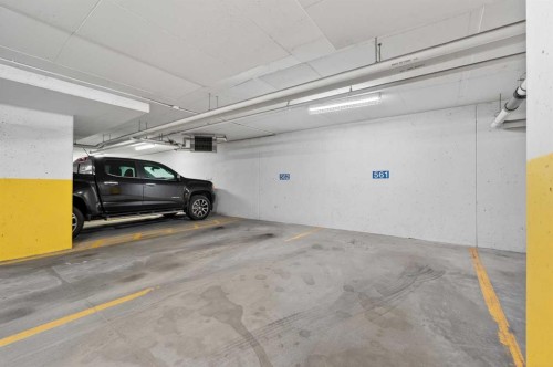 102-211 Quarry Way Se, Calgary, AB - Indoor Photo Showing Garage