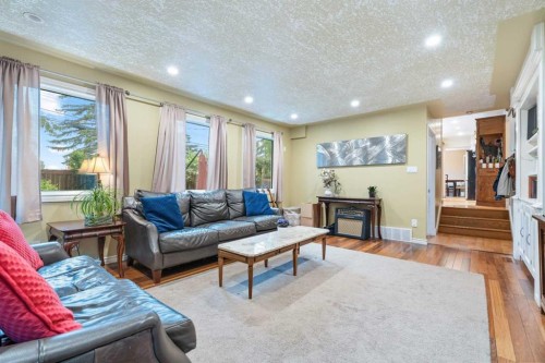 411 Wilderness Place Se, Calgary, AB - Indoor Photo Showing Living Room With Fireplace