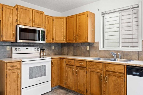 159 Shawinigan Drive Sw, Calgary, AB - Indoor Photo Showing Kitchen With Double Sink