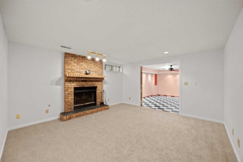 159 Shawinigan Drive Sw, Calgary, AB - Indoor Photo Showing Living Room With Fireplace
