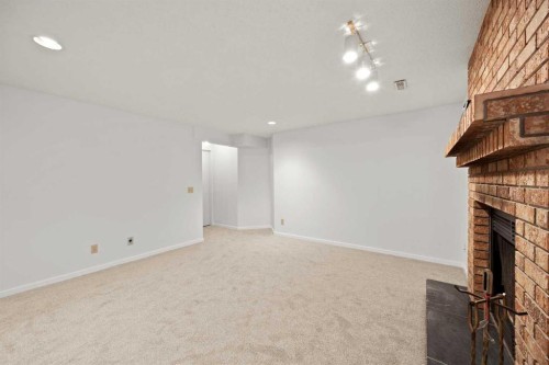 159 Shawinigan Drive Sw, Calgary, AB - Indoor Photo Showing Other Room With Fireplace