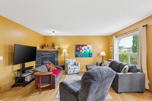 23 Tuscarora Close Nw, Calgary, AB - Indoor Photo Showing Living Room With Fireplace