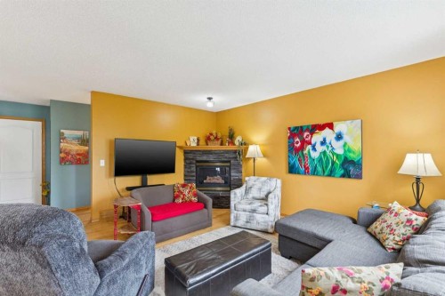 23 Tuscarora Close Nw, Calgary, AB - Indoor Photo Showing Living Room With Fireplace