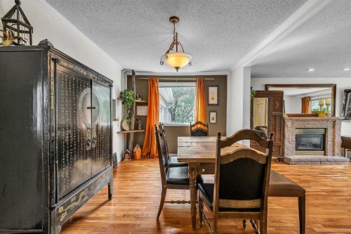 712 14 Street Se, Calgary, AB - Indoor Photo Showing Dining Room With Fireplace