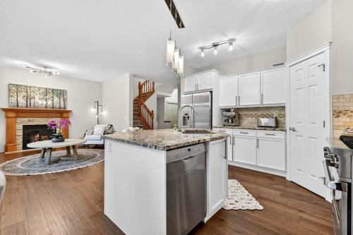 13 Cougar Ridge Circle Sw, Calgary, AB - Indoor Photo Showing Kitchen With Fireplace With Stainless Steel Kitchen With Upgraded Kitchen