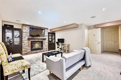 13 Cougar Ridge Circle Sw, Calgary, AB - Indoor Photo Showing Living Room With Fireplace