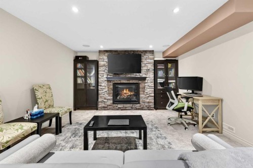 13 Cougar Ridge Circle Sw, Calgary, AB - Indoor Photo Showing Living Room With Fireplace