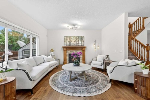 13 Cougar Ridge Circle Sw, Calgary, AB - Indoor Photo Showing Living Room With Fireplace