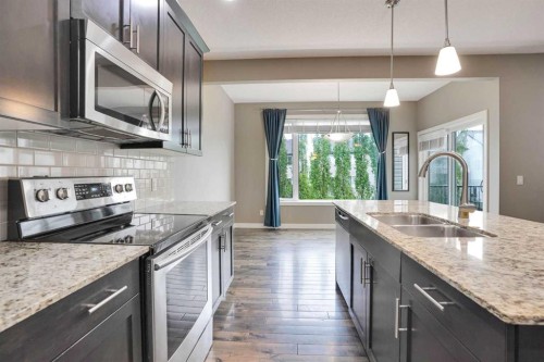 3 Sunset Court, Cochrane, AB - Indoor Photo Showing Living Room With Fireplace